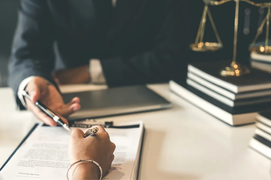 Two people at desk looking over bequest paperwork during probate litigation